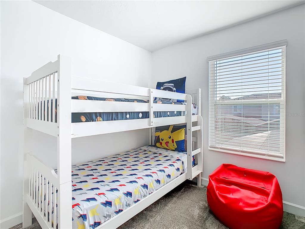 2957 Simile Street Kissimmee, FL 34746 - Photo 27 of 67 a bedroom with a bed and a window