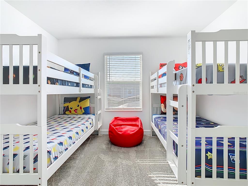 2957 Simile Street Kissimmee, FL 34746 - Photo 28 of 67 a bedroom with furniture and a large window