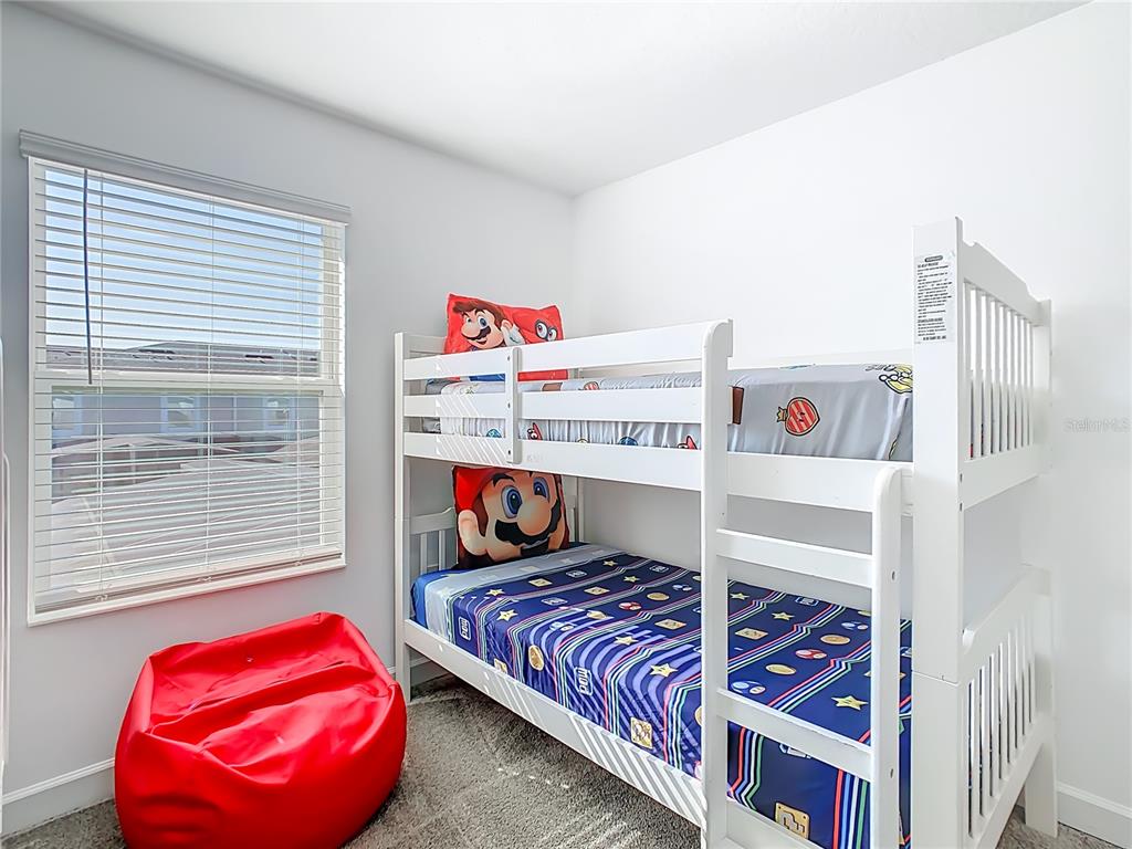 2957 Simile Street Kissimmee, FL 34746 - Photo 30 of 67 a bed room with a bed and a chair