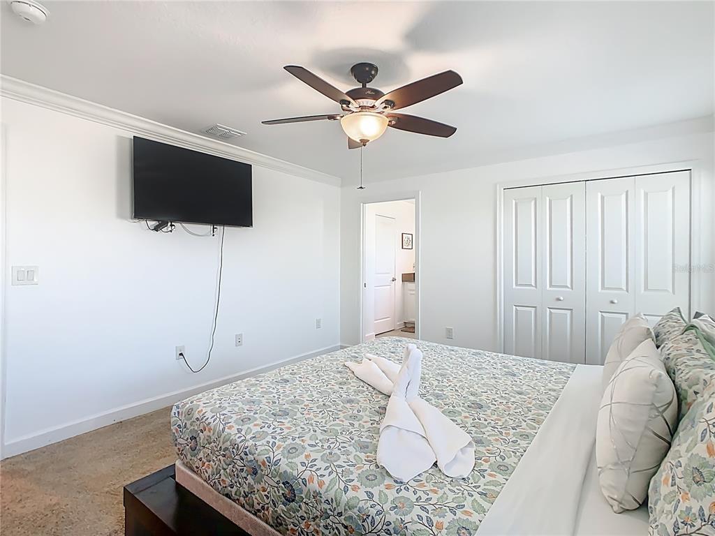 2957 Simile Street Kissimmee, FL 34746 - Photo 32 of 67 a bedroom with a bed and a flat screen tv