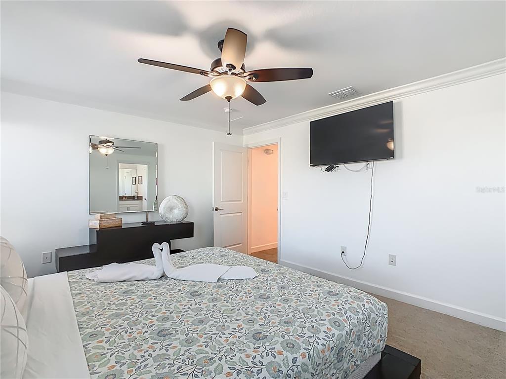 2957 Simile Street Kissimmee, FL 34746 - Photo 33 of 67 a bedroom with a bed and a flat screen tv