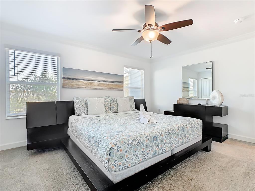 2957 Simile Street Kissimmee, FL 34746 - Photo 34 of 67 a bedroom with a bed chandelier and a window