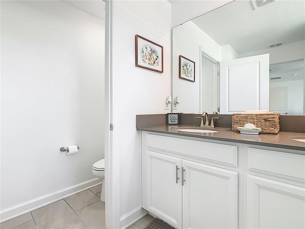 2957 Simile Street Kissimmee, FL 34746 - Photo 35 of 67 a bathroom with a sink and a mirror