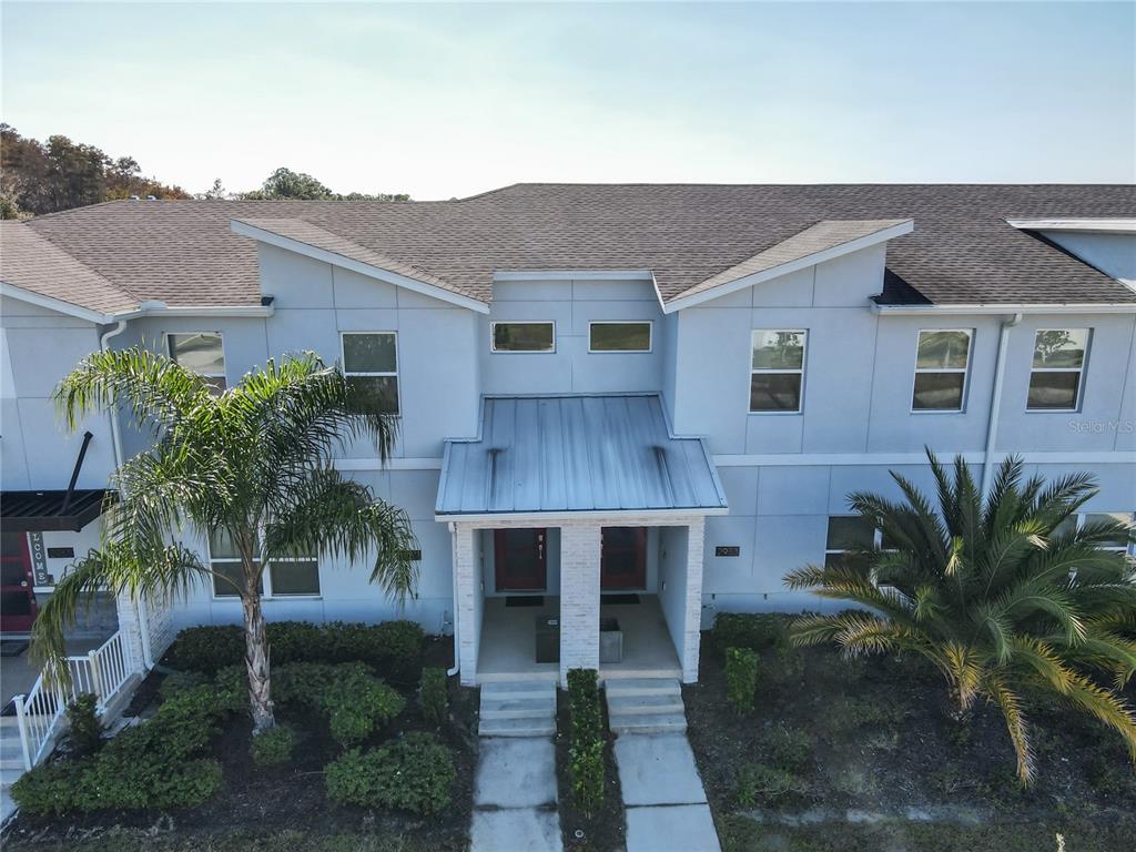 2957 Simile Street Kissimmee, FL 34746 - Photo 61 of 67 a front view of a house with a yard and potted plants