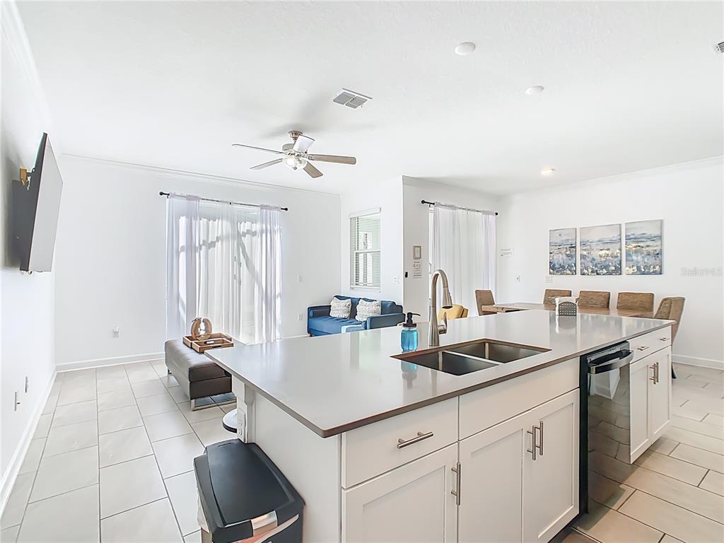 2957 Simile Street Kissimmee, FL 34746 - Photo 8 of 67 a kitchen with a sink and a refrigerator