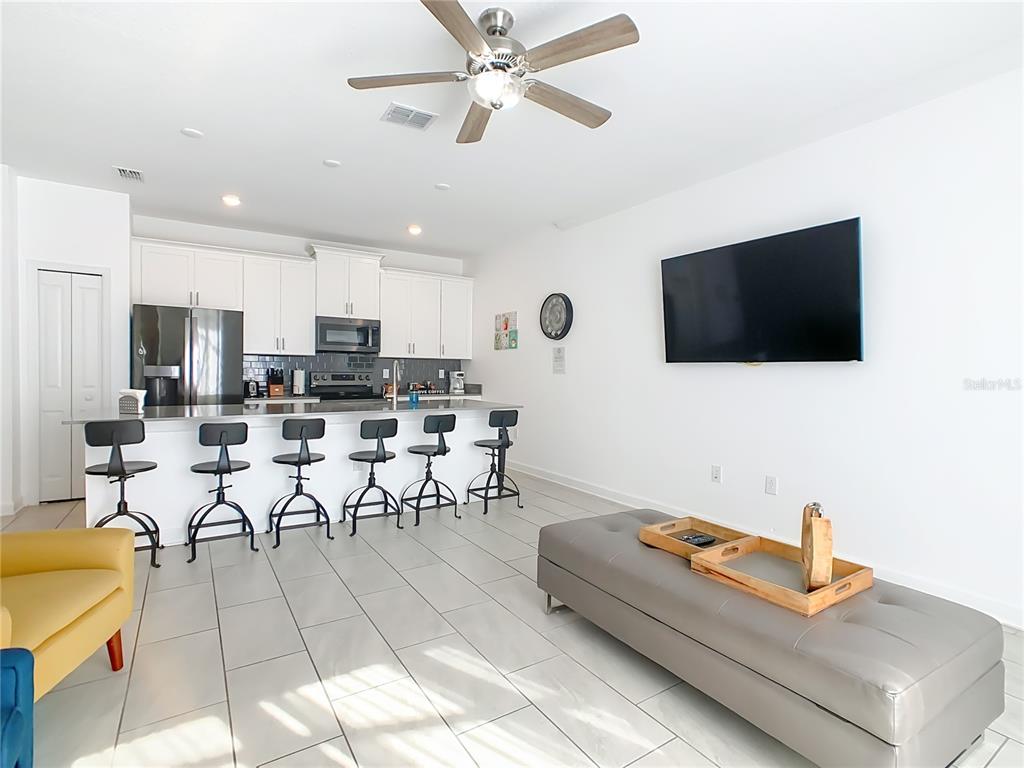 2957 Simile Street Kissimmee, FL 34746 - Photo 9 of 67 a living room with furniture and a flat screen tv