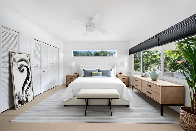 a bedroom with a large bed and a chandelier