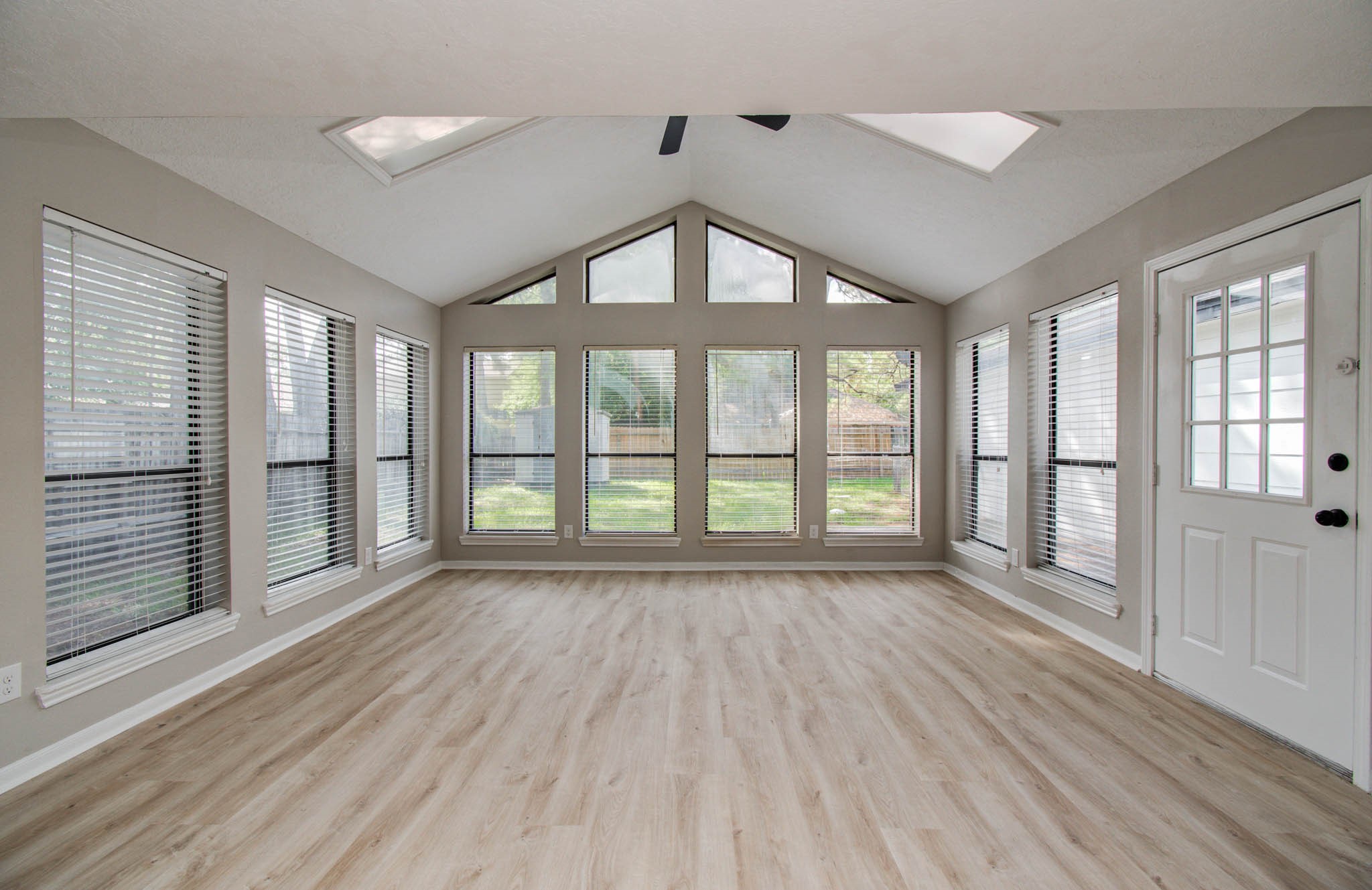 4735 Theall Road Houston, TX 77066 - Photo 11 of 36 a view of an empty room with wooden floor and a window