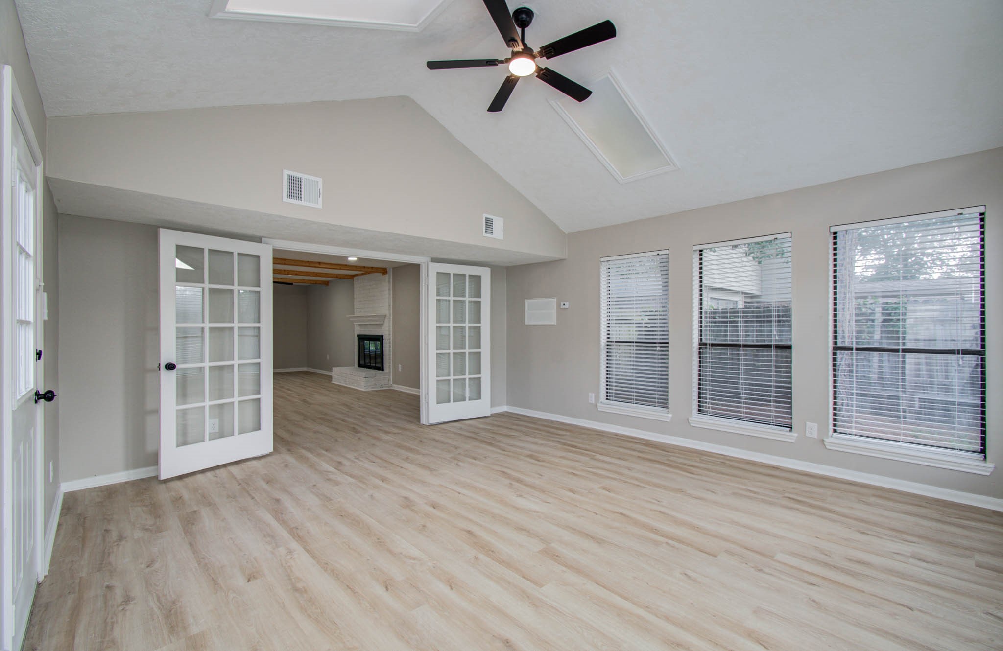 4735 Theall Road Houston, TX 77066 - Photo 13 of 36 a view of empty room with wooden floor and fan