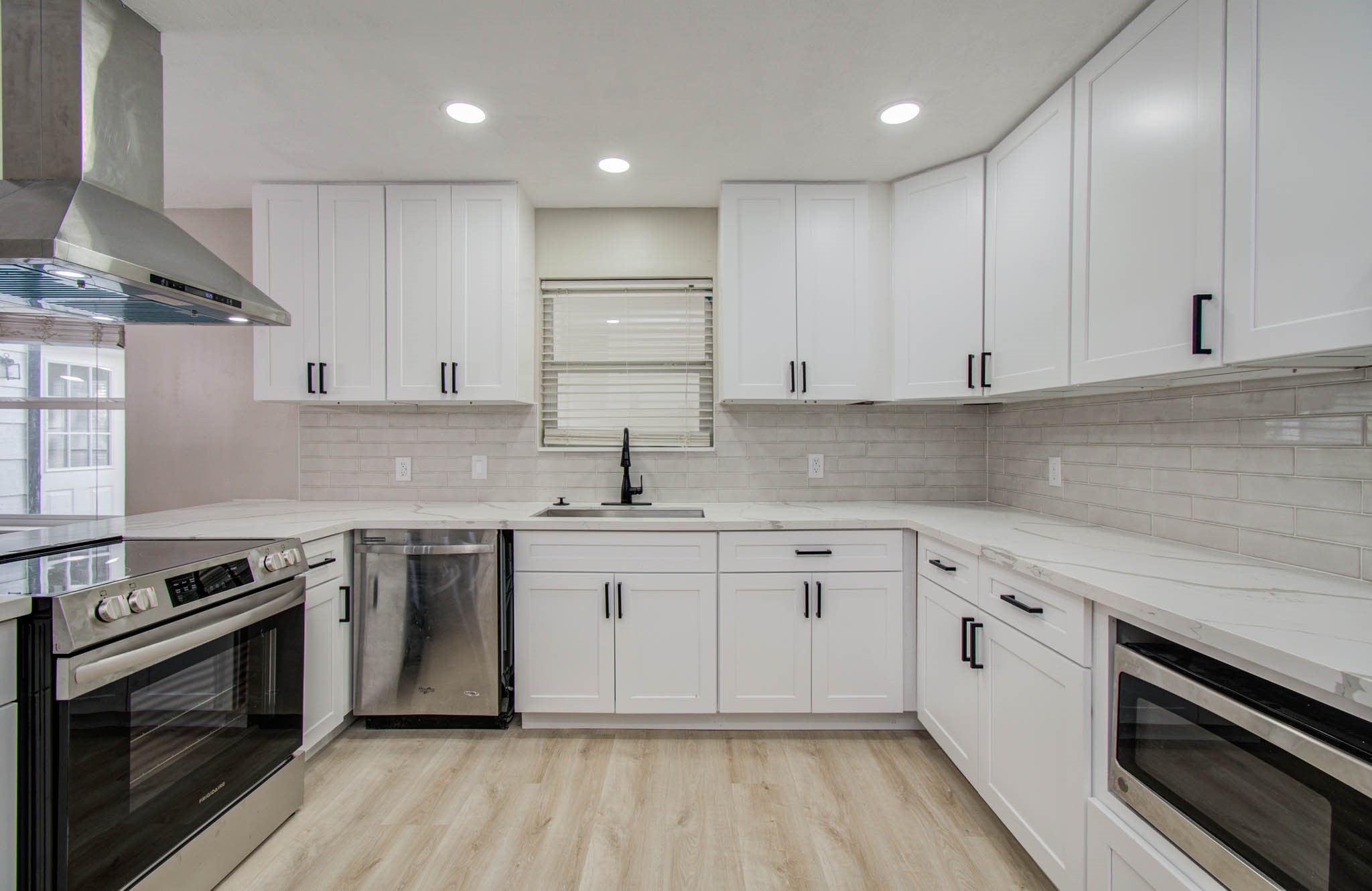 4735 Theall Road Houston, TX 77066 - Photo 17 of 36 a kitchen with stainless steel appliances granite countertop a stove and a sink