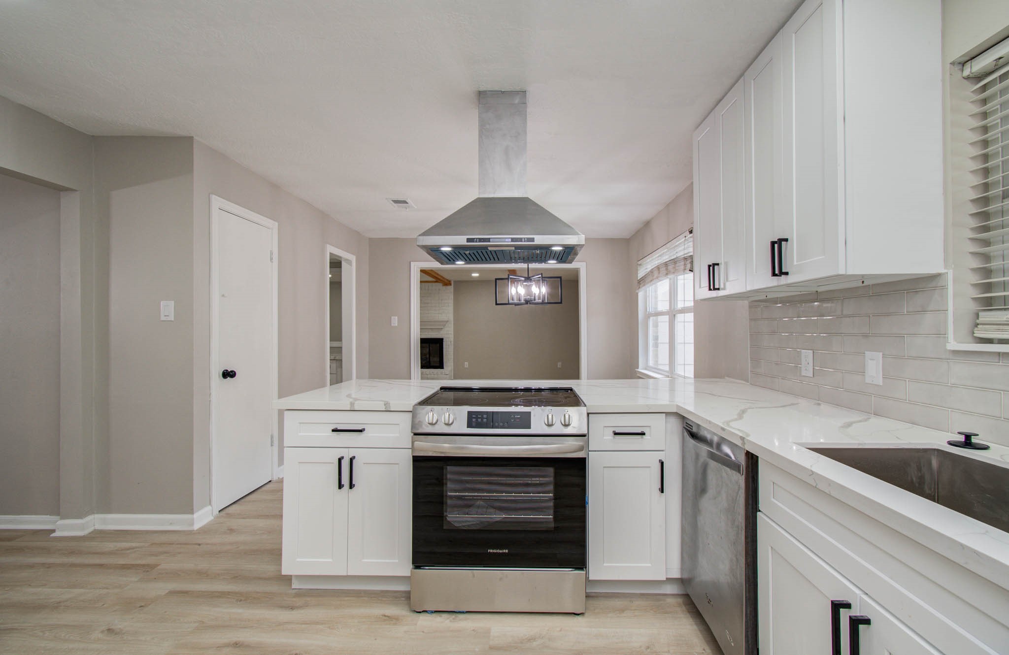 4735 Theall Road Houston, TX 77066 - Photo 20 of 36 a kitchen with a stove and a sink