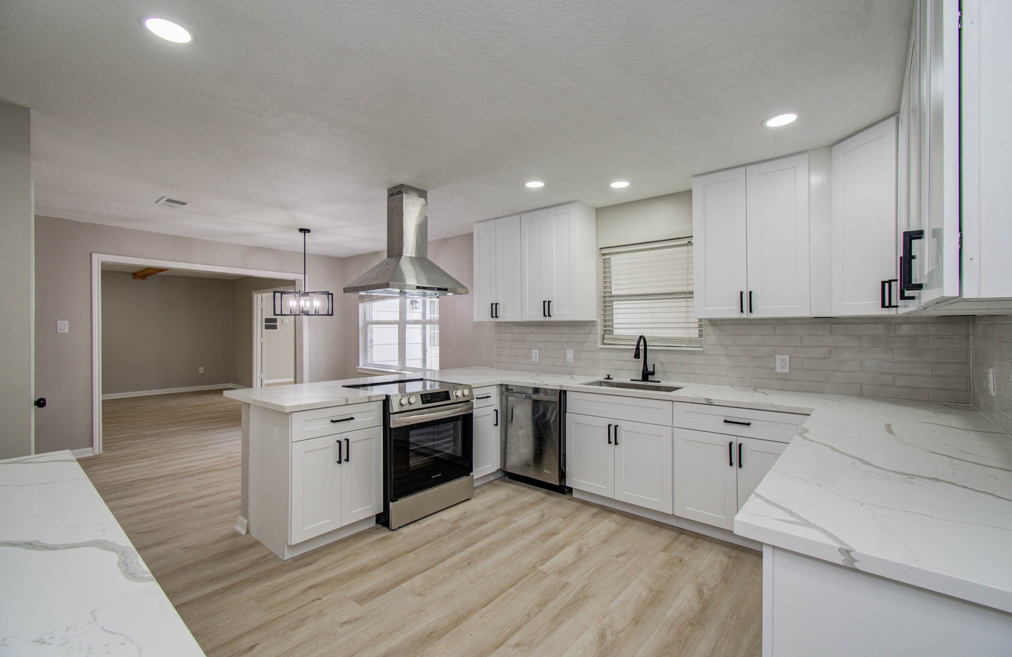 4735 Theall Road Houston, TX 77066 - Photo 21 of 36 a large kitchen with granite countertop a stove top oven sink and cabinets