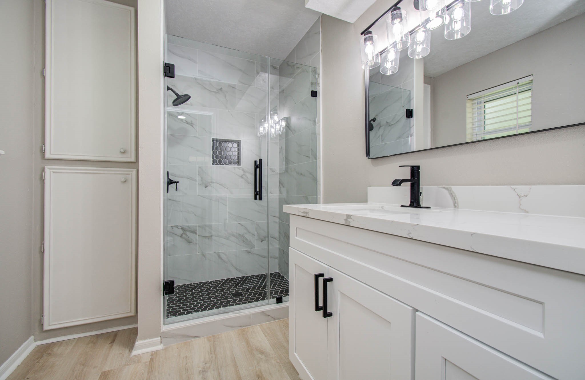 4735 Theall Road Houston, TX 77066 - Photo 23 of 36 a bathroom with a shower sink and mirror