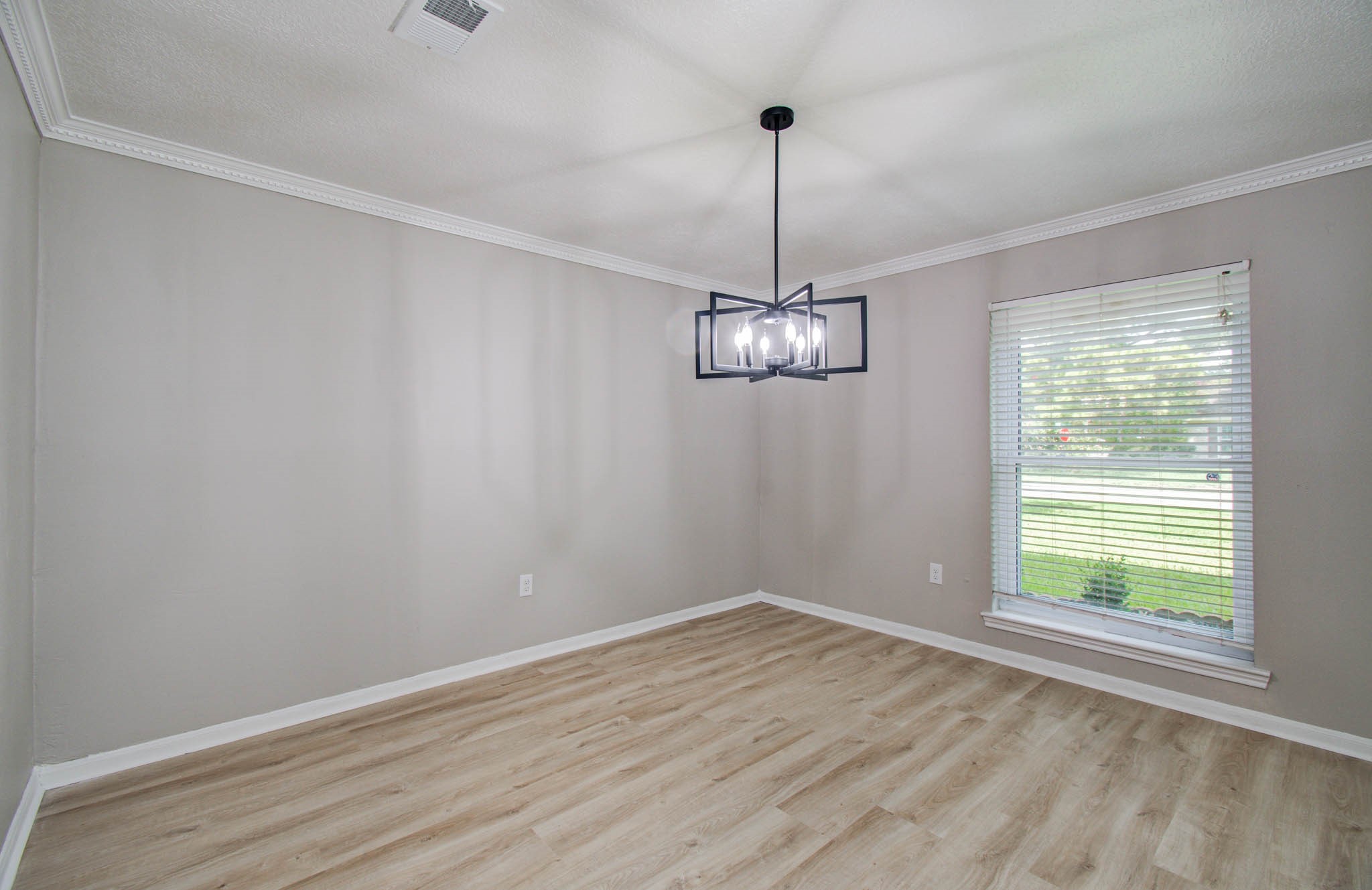 4735 Theall Road Houston, TX 77066 - Photo 25 of 36 a view of empty room with wooden floor and ceiling fan