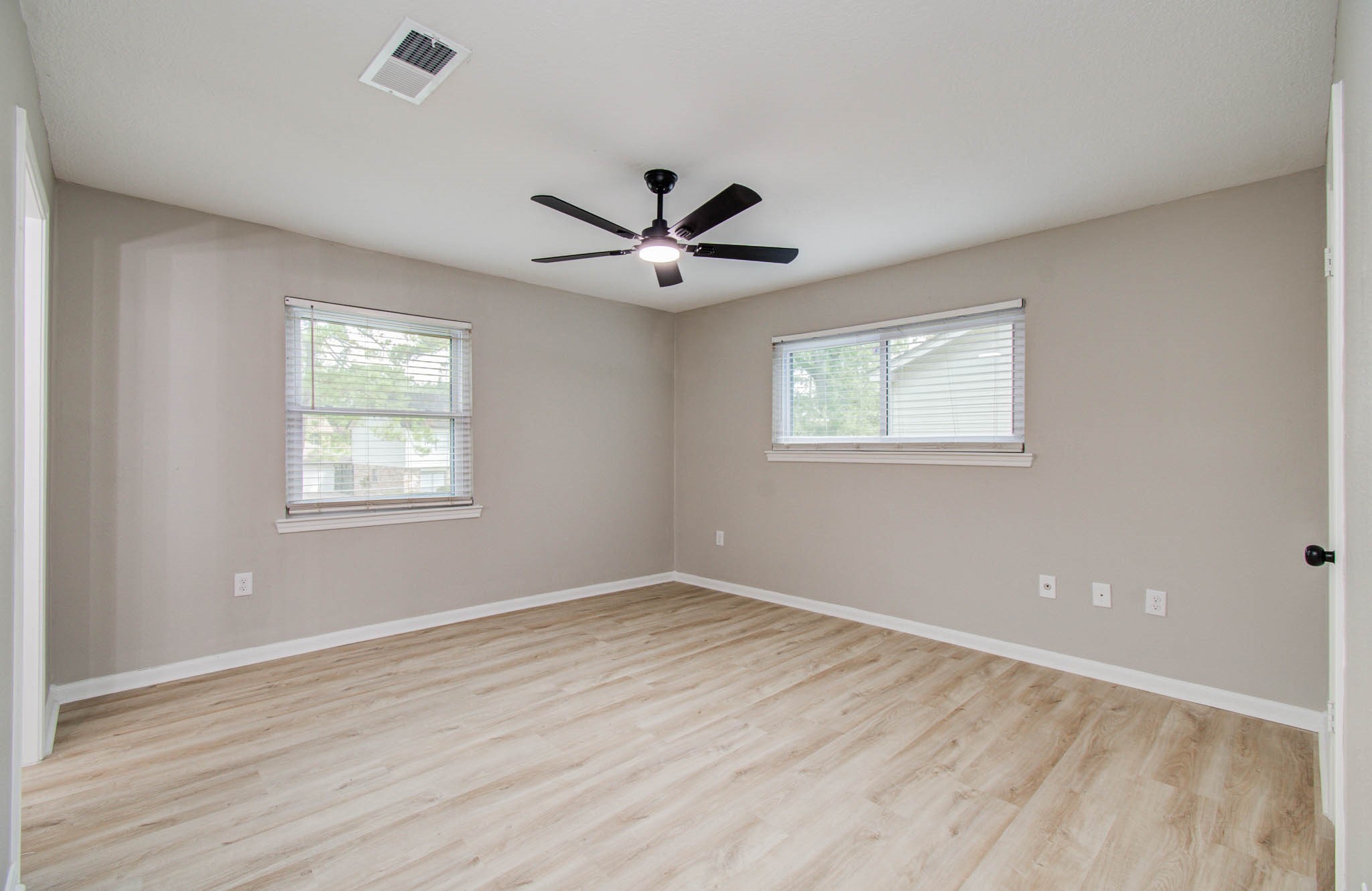 4735 Theall Road Houston, TX 77066 - Photo 27 of 36 wooden floor in an empty room with a window
