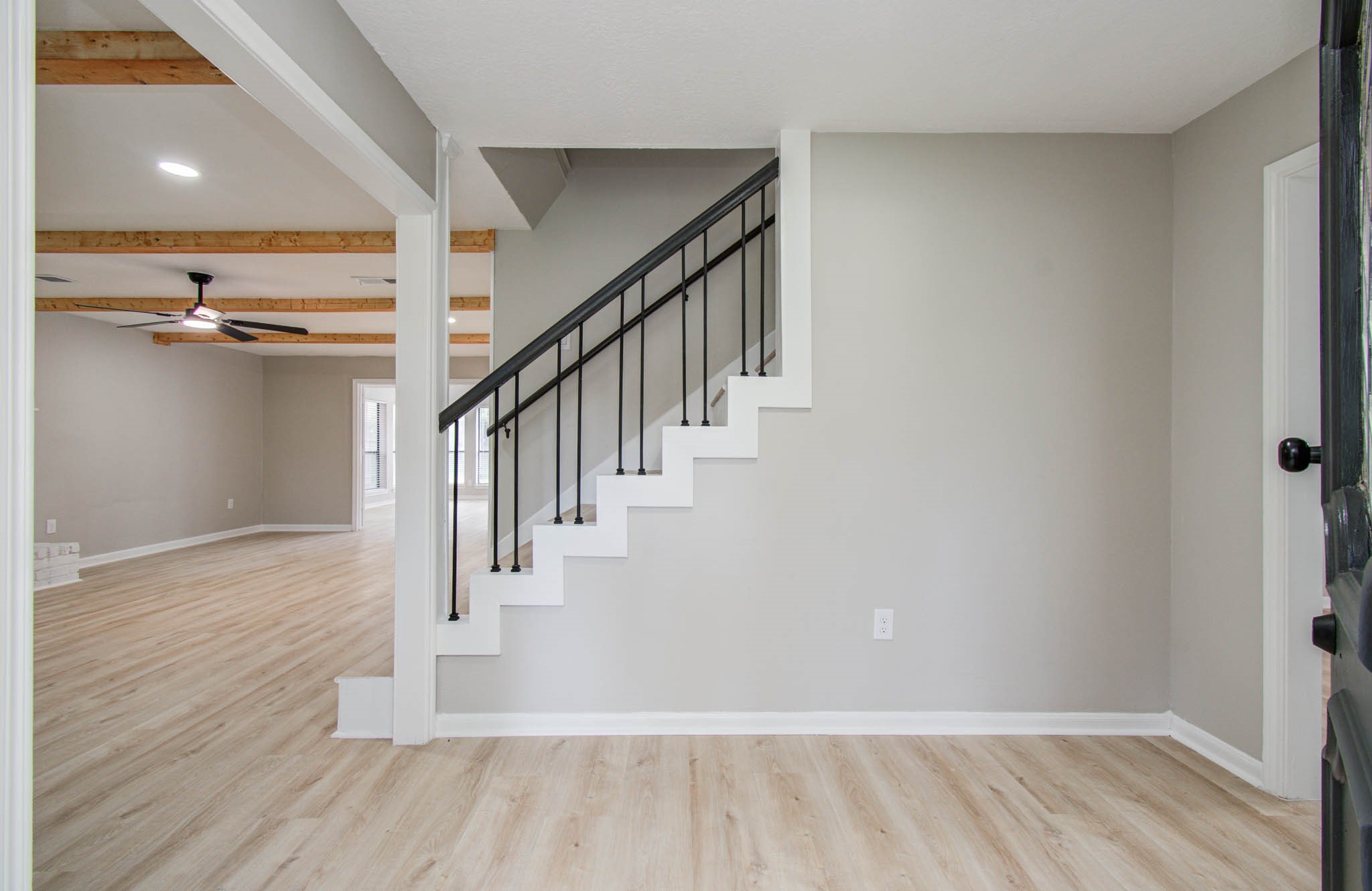 4735 Theall Road Houston, TX 77066 - Photo 6 of 36 a view of hallway with stairs and wooden floor