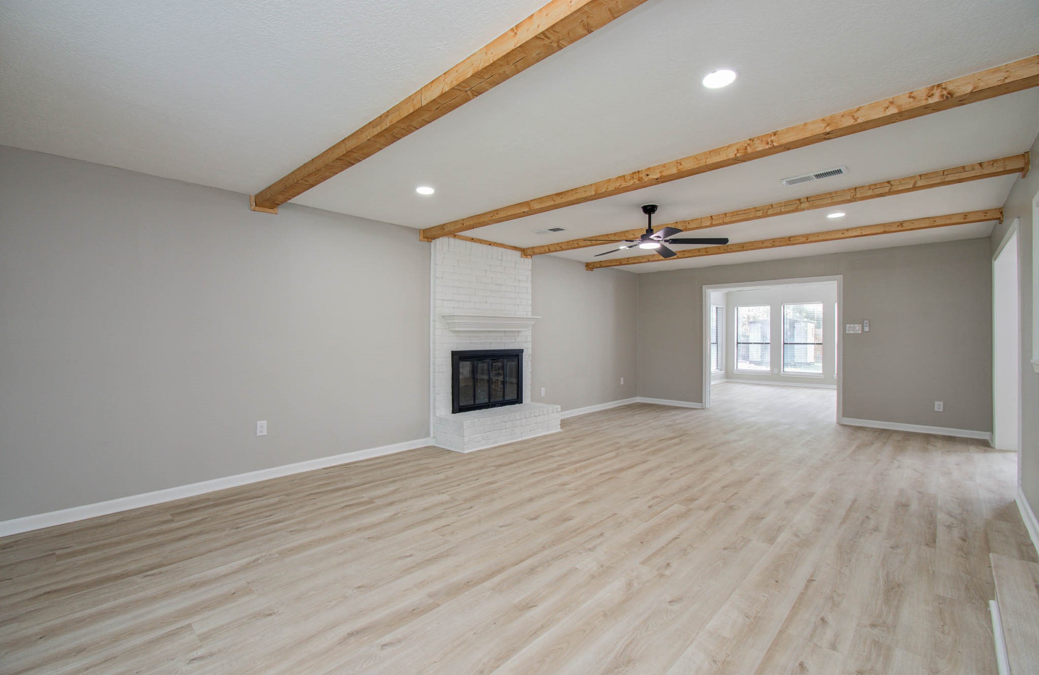 4735 Theall Road Houston, TX 77066 - Photo 7 of 36 a view of an empty room with a fireplace and a window