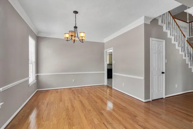 a view of an entryway with wooden floor and a chandelier