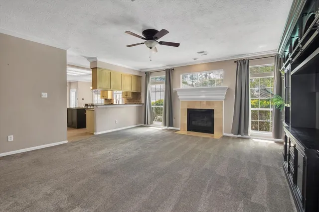 a view of an empty room with a fireplace and a window