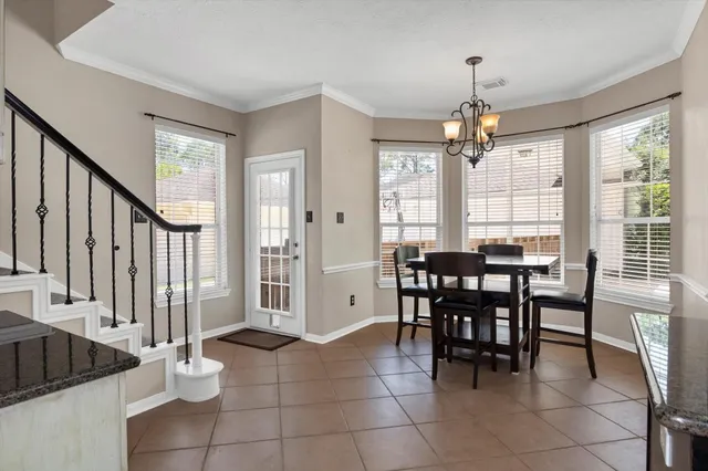 a view of a dining room with furniture and chandelier