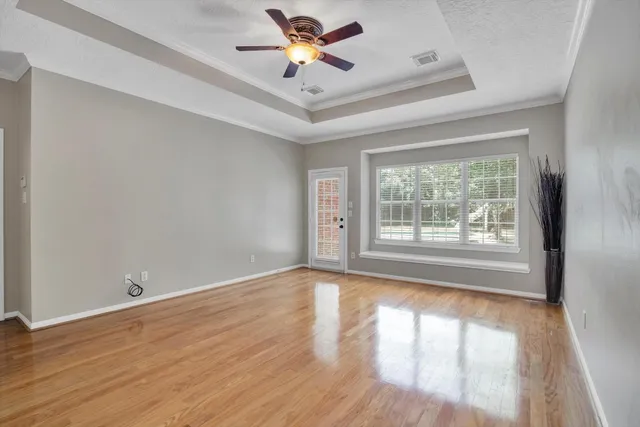 a view of an empty room and wooden floor