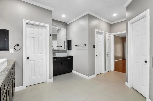 a bathroom with a bathtub and a potted plant