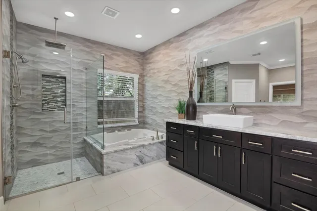 a bathroom with a bathtub sink and mirror