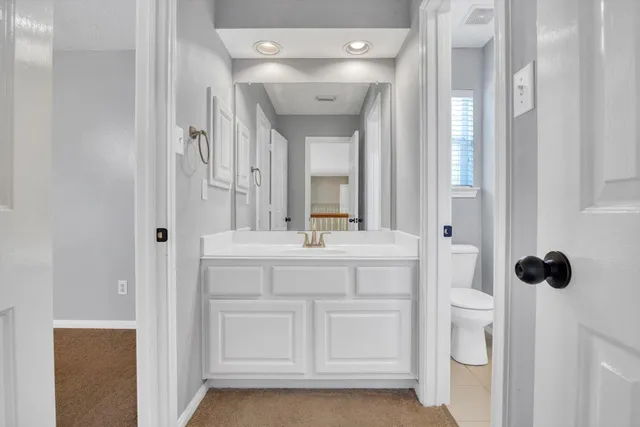 a view of an empty room with a ceiling fan