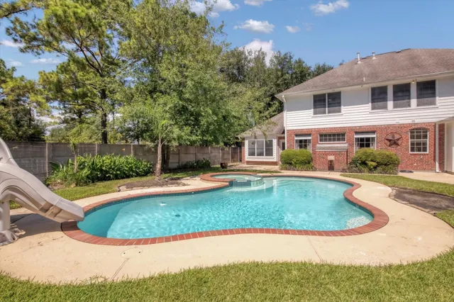 a view of a house with swimming pool and sitting area