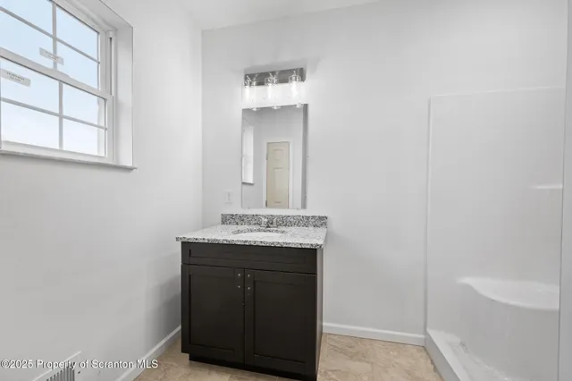 a white toilet sitting next to a bathroom