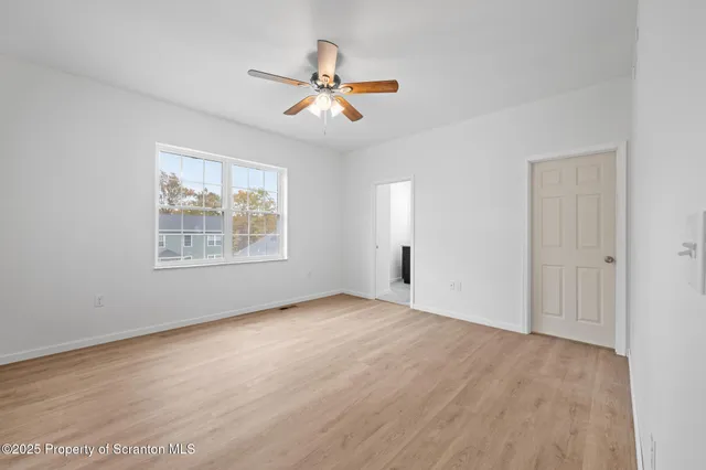 a bathroom with a granite countertop sink a toilet and a mirror