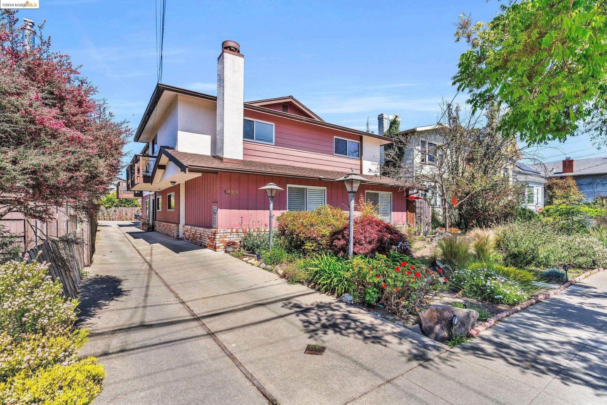 1233 Broadway, Unit C Alameda, CA 94501 - Photo 1 of 1 a front view of a house with a garden