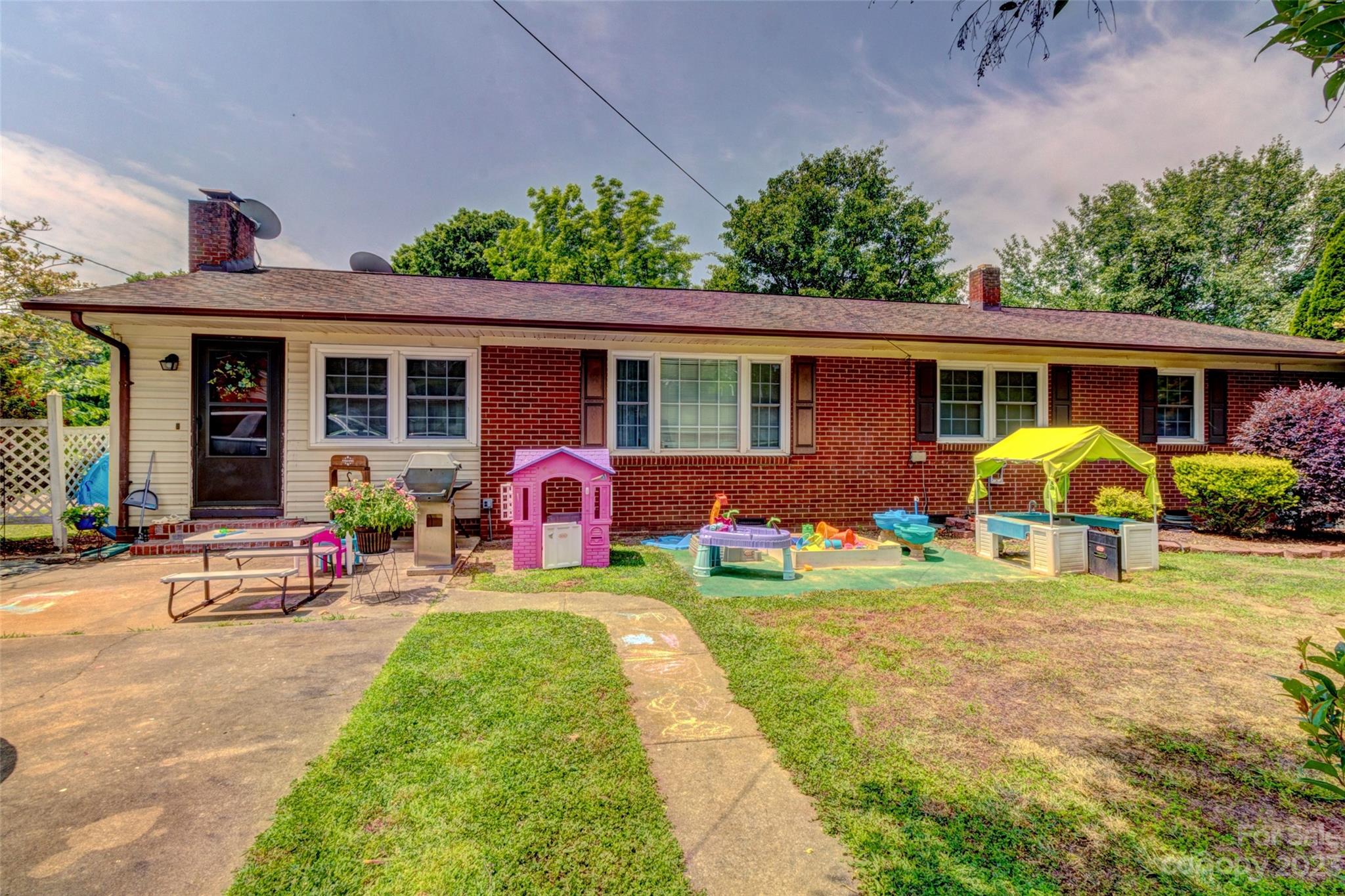 1408 Delview Road Cherryville, NC 28021 - Photo 23 of 23 a view of a backyard with table and chairs under an umbrella