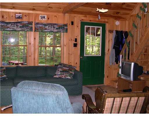 138 Bemis Road Oquossoc, ME 04964 - Photo 14 of 21 Living Room. Living area, woods...