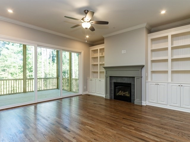 6920 Ray Family Farm Court, Unit LT20 Raleigh, NC 27613 - Photo 6 of 22 Family room with built-ins flanking the gas fireplace. Triple slider to the screened porch. Photo of Similar Home