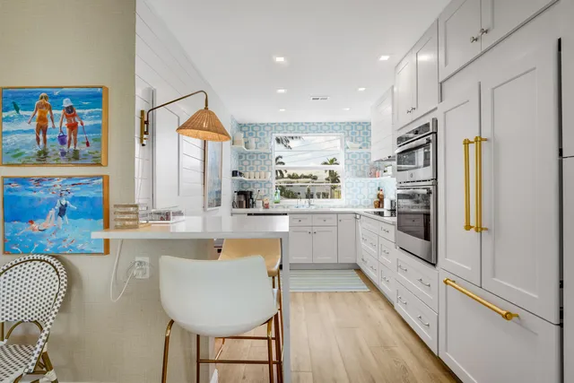 a kitchen with white cabinets and white appliances