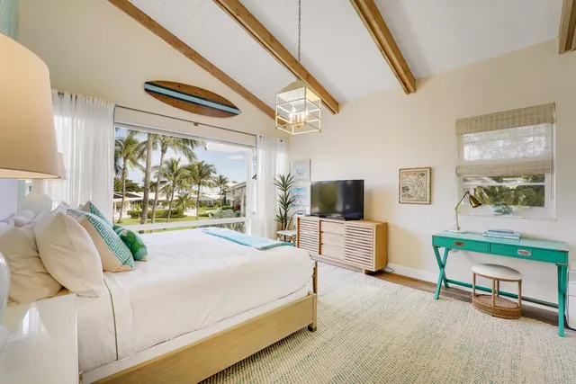 a bedroom with furniture and a flat screen tv