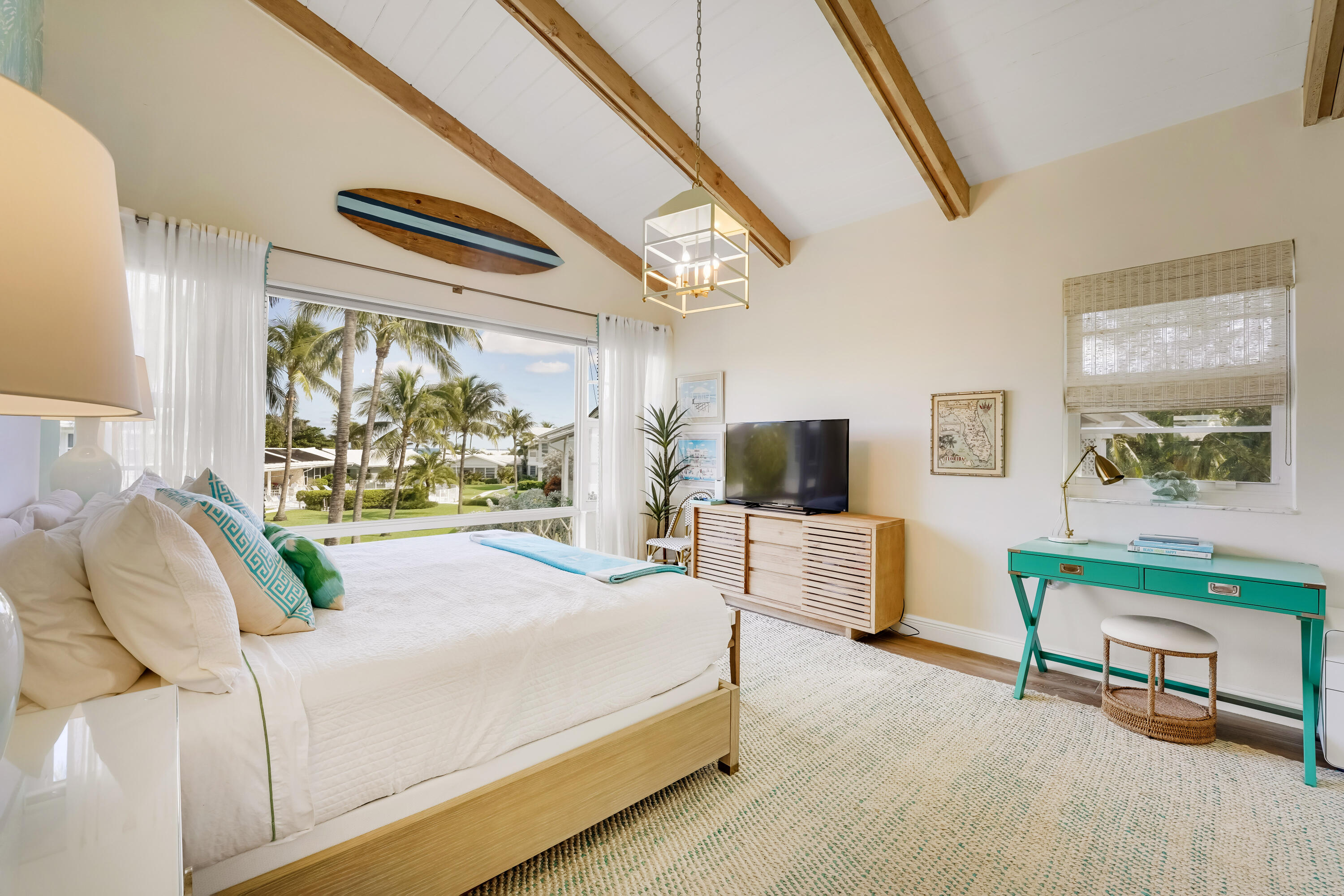 320 South Ocean Boulevard, Unit UK Delray Beach, FL 33483 - Photo 14 of 27 a bedroom with a bed a flat screen tv and a large window