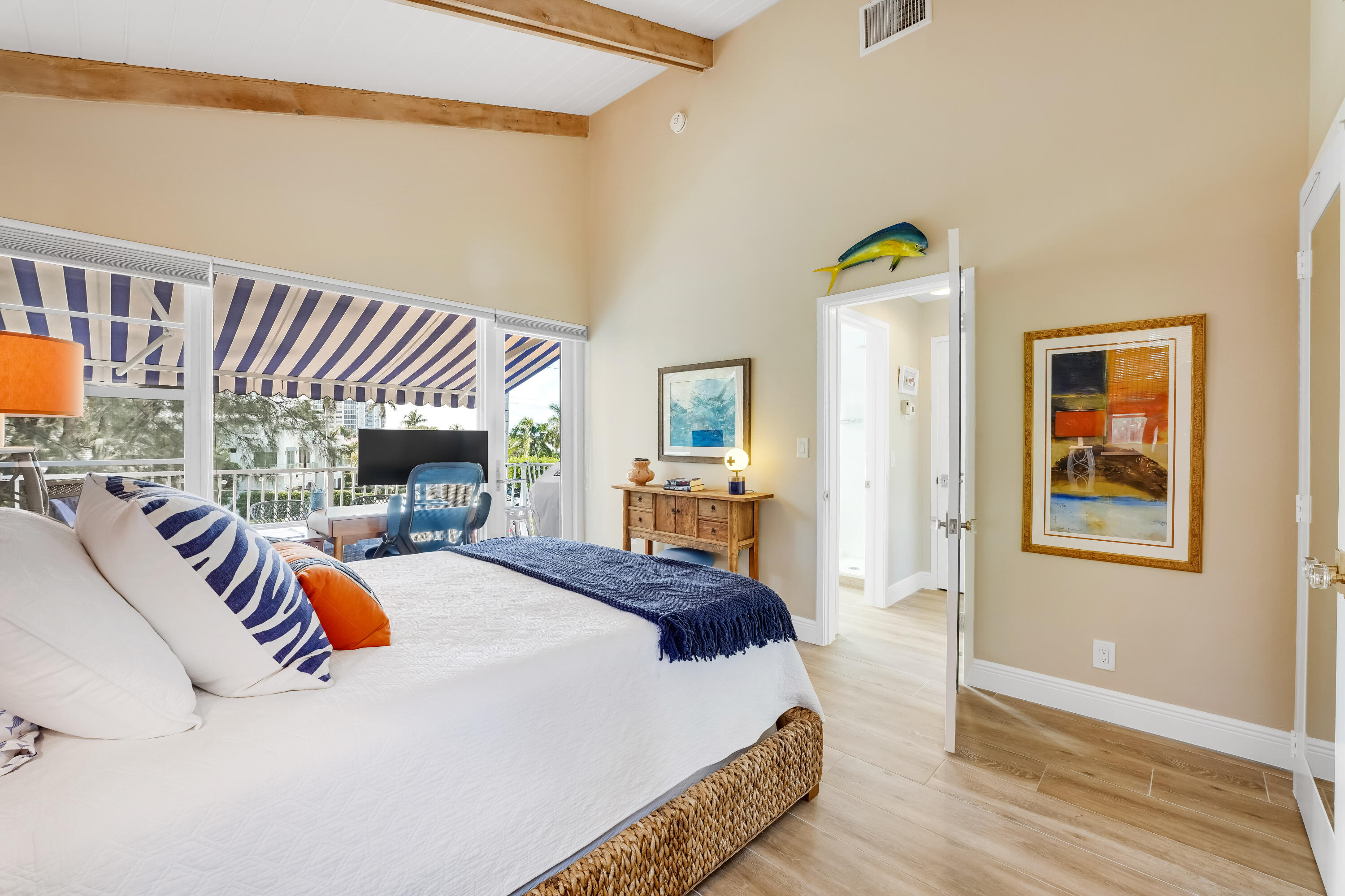 320 South Ocean Boulevard, Unit UK Delray Beach, FL 33483 - Photo 18 of 27 a bedroom with a bed and wooden floor