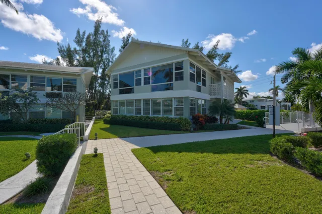 an aerial view of a house with swimming pool and outdoor seating
