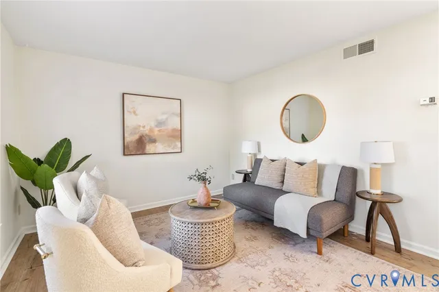 a living room with furniture potted plant and a large mirror