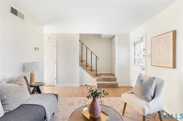 a living room with furniture and a potted plant