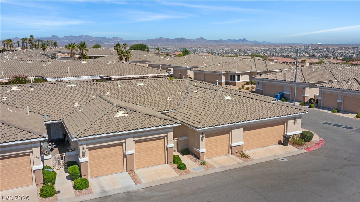 3376 Partridge Run Street Laughlin, NV 89029 - Photo 66 of 92 An aerial perspective reveals a dense community of homes under desert skies with mountain views.