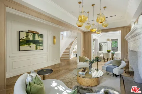 a living room with furniture and a chandelier