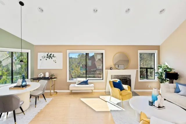 a living room with fireplace furniture and a large window