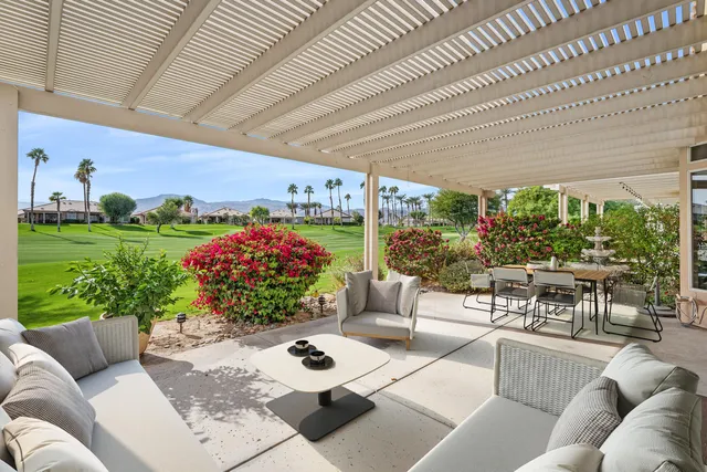 a living room with furniture and a garden