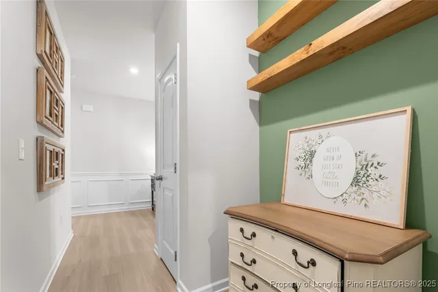 a bathroom with a sink a toilet a lamp and shower curtain