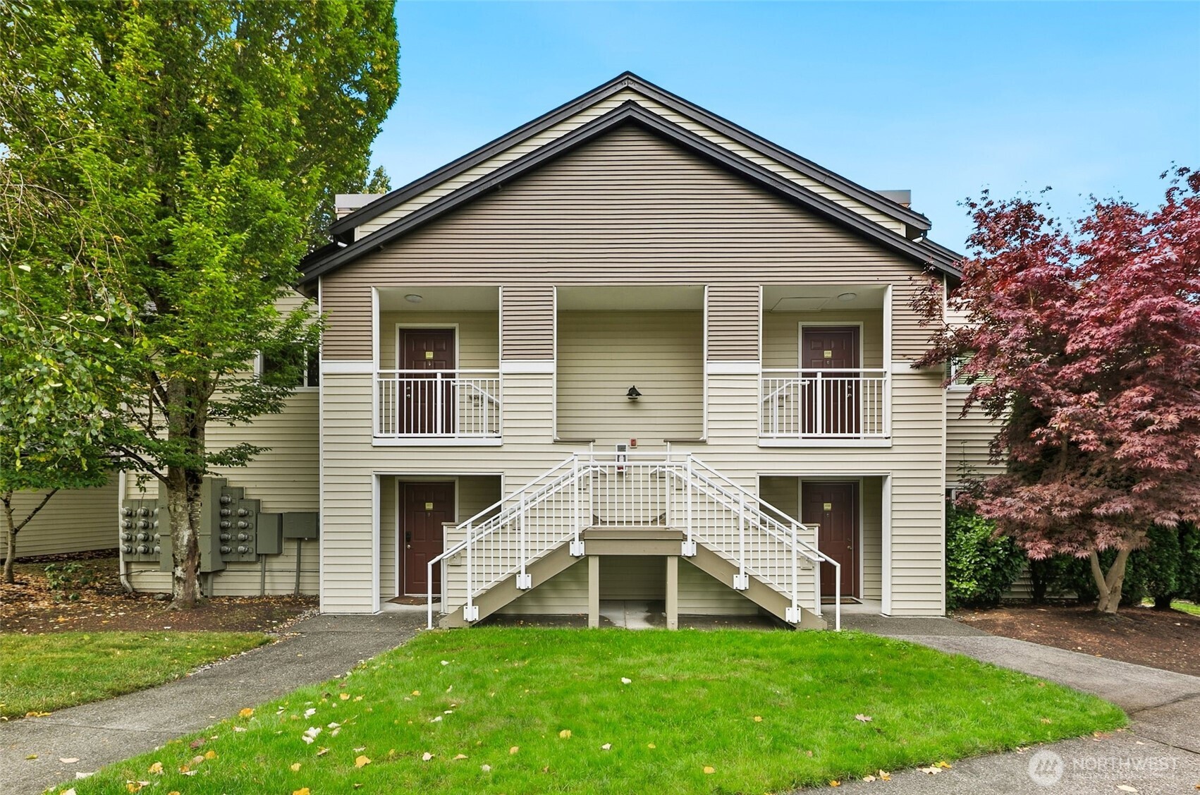 a white house with a small yard and more windows