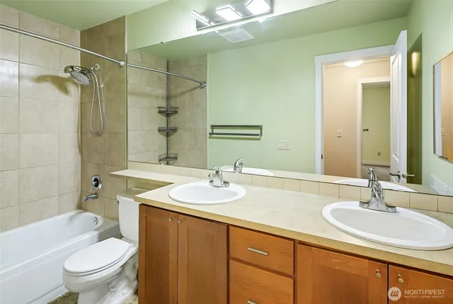 a bathroom with a sink toilet vanity and shower