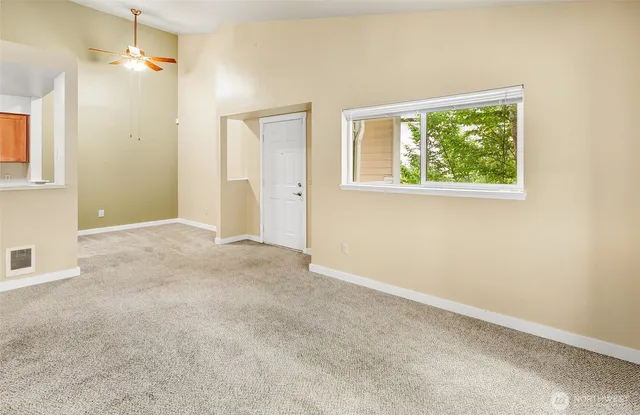 a view of an empty room with a window